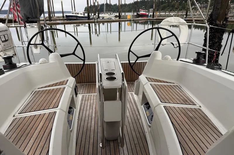Slide: The Image of Cockpit of 2016 Jeanneau Sun Odyssey 349 sailboat with dual steering wheels. - 2