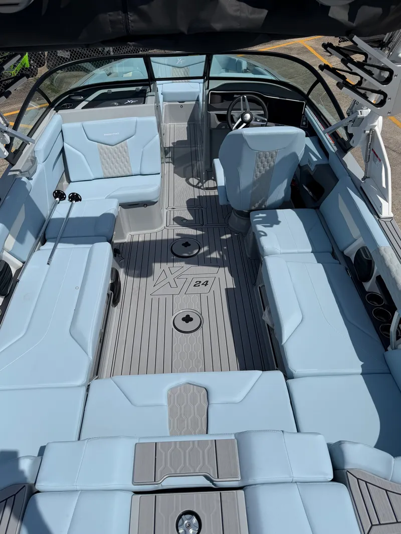 Slide: The Image of Interior of 2026 MasterCraft XT24 boat with blue seating. - 13