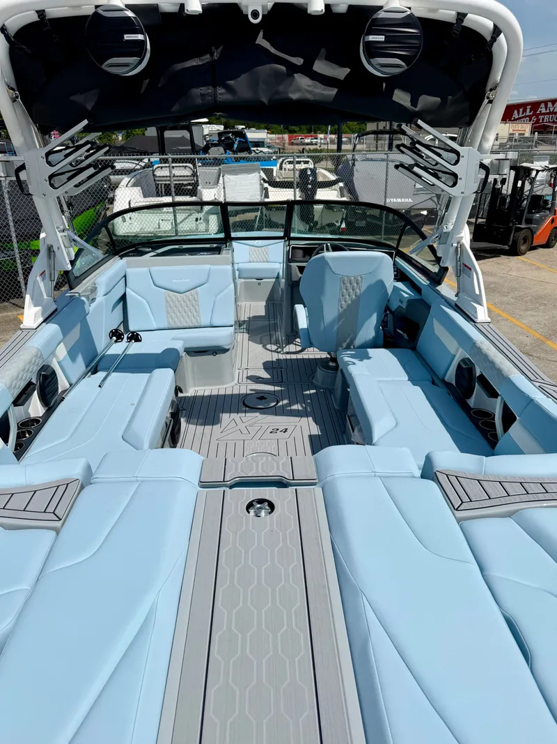 Slide: The Image of Interior of 2026 MasterCraft XT24 boat with blue seating. - 14