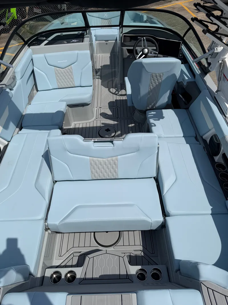 Slide: The Image of Interior of 2026 MasterCraft XT24 with luxurious blue seating. - 16