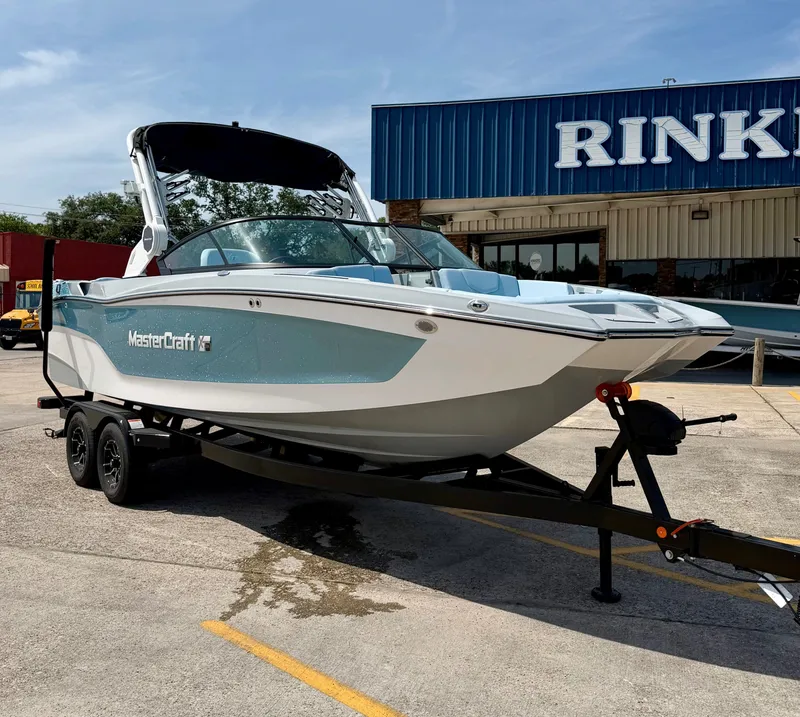 Slide: The Image of 2026 MasterCraft XT24 boat on trailer in front of store. - 4