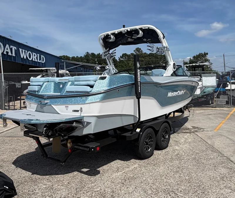 Slide: The Image of 2026 MasterCraft XT24 boat on trailer at Boat World. - 6