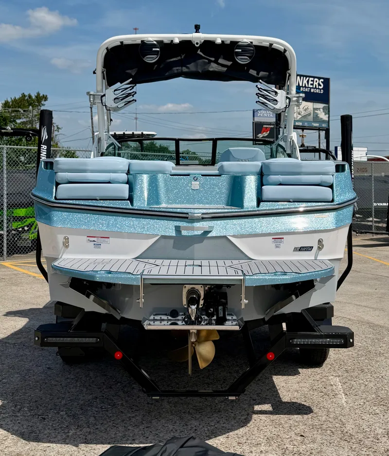Slide: The Image of Rear view of a 2026 MasterCraft XT24 boat in a parking lot. - 9