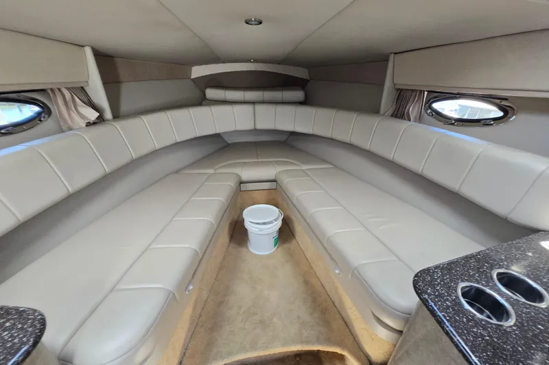 Slide: The Image of Interior of a 2005 Formula 330 Sun Sport boat with beige seating and porthole windows. - 15