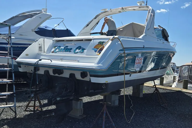 Slide: The Image of 2005 Formula 330 Sun Sport boat on stands, for sale, with "Calm C's" name. - 24