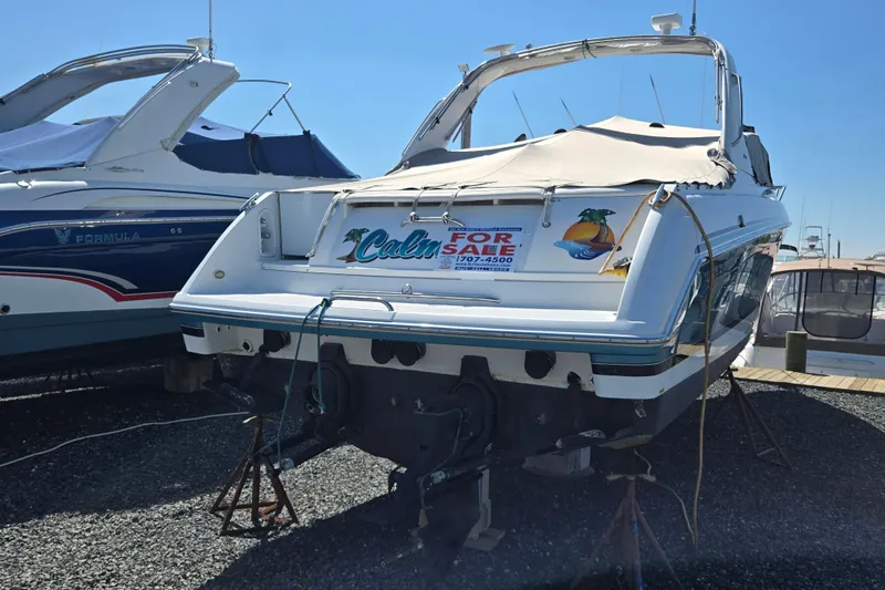 Slide: The Image of 2005 Formula 330 Sun Sport boat for sale, docked and covered, with visible contact information. - 27