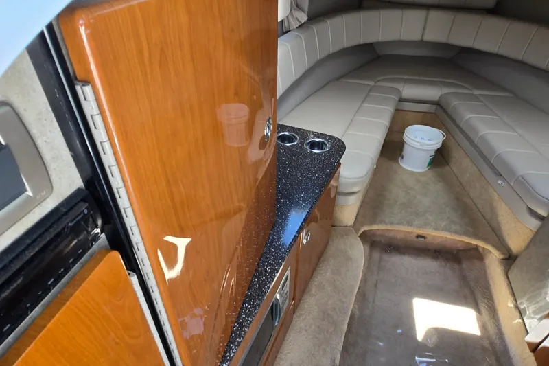Slide: The Image of Interior of 2005 Formula 330 Sun Sport boat with seating and wooden cabinetry. - 9