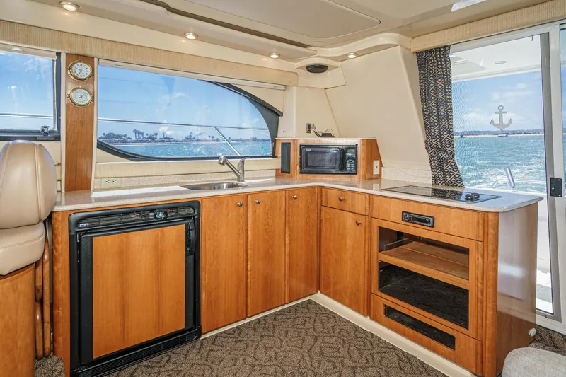 Slide: The Image of Interior of 2003 Meridian 341 Sedan yacht with kitchen and ocean view. - 25
