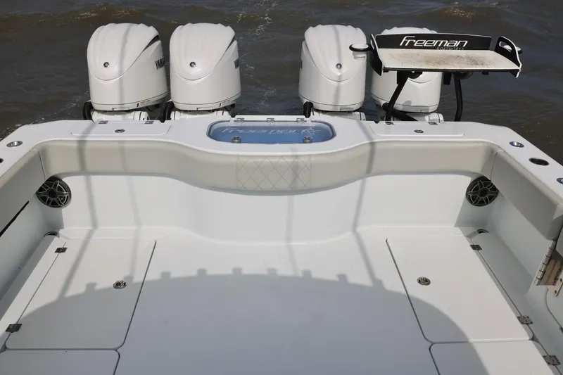 Slide: The Image of 2024 Freeman 38 boat with four Yamaha engines, spacious deck, and fishing station. - 10