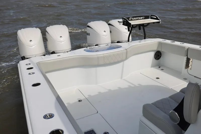 Slide: The Image of 2024 Freeman 38 boat with four Yamaha engines on open water. - 11