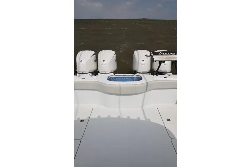 Slide: The Image of 2024 Freeman 38 boat with four outboard motors on open water. - 12
