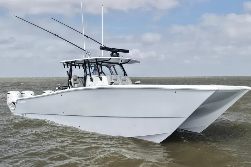 Slide: The Image of 2024 Freeman 38 boat on water, featuring sleek design and dual outboard motors. - 27