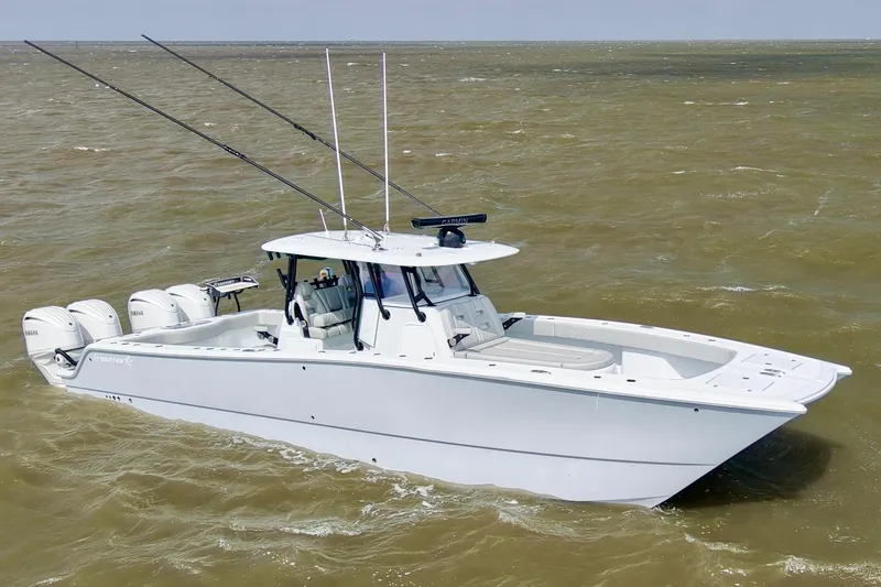 Slide: The Image of 2024 Freeman 38 boat with triple outboard engines on choppy water. - 4