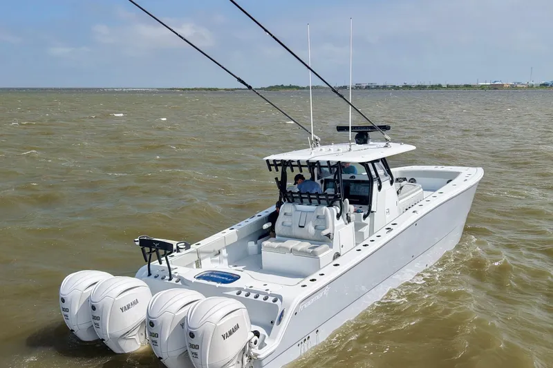 Slide: The Image of 2024 Freeman 38 boat with Yamaha engines cruising on open water. - 5