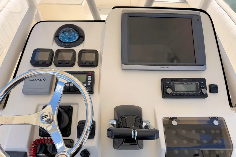 Slide: The Image of Helm of 2003 Intrepid 322 Cuddy with Garmin navigation and control instruments. - 11