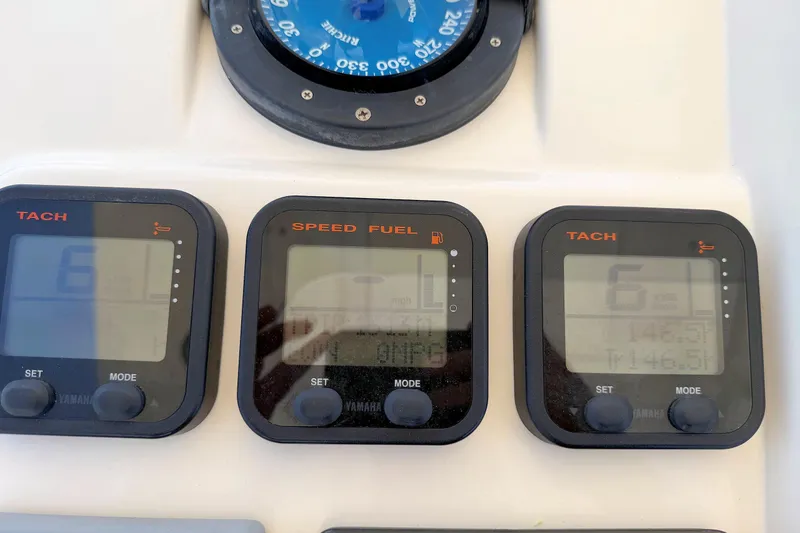 Slide: The Image of Digital gauges on a 2003 Intrepid 322 Cuddy boat dashboard. - 12