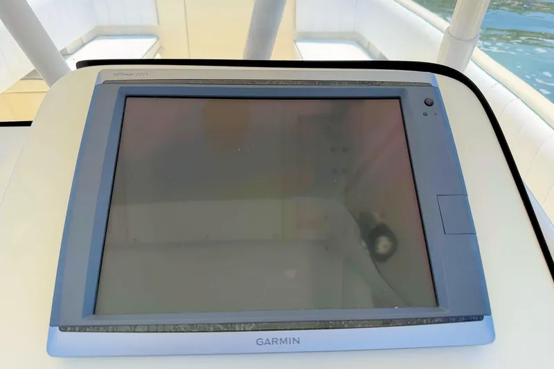 Slide: The Image of Garmin marine display on 2003 Intrepid 322 Cuddy boat dashboard. - 13