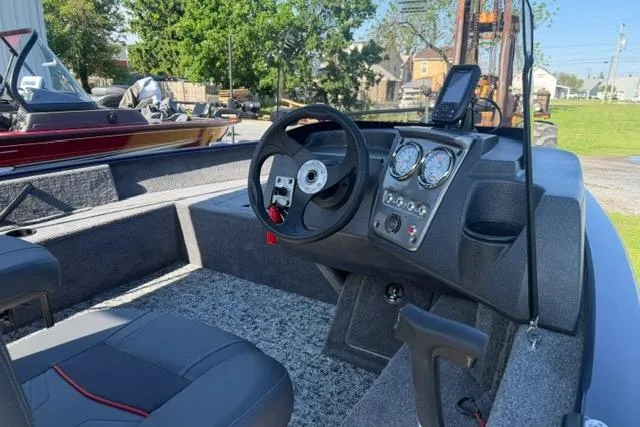 Slide: The Image of 2026 Tracker Pro Guide V-16 SC boat interior with steering wheel and dashboard gauges. - 8