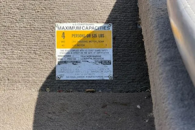 Slide: The Image of 1999 Tracker Pro Team 165 capacity label, showing maximum 4 persons or 535 lbs. - 5