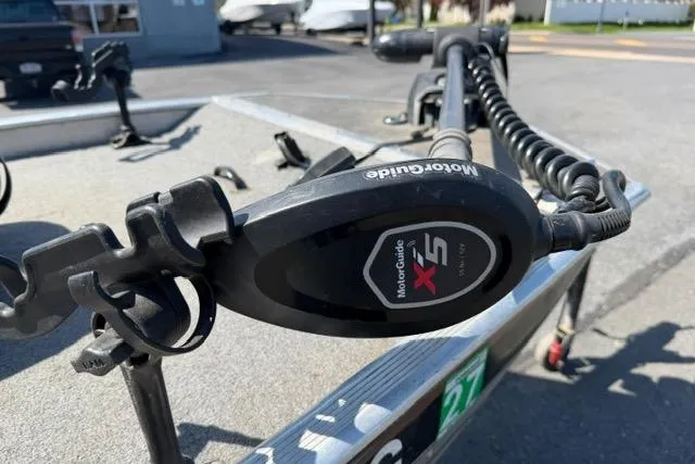 Slide: The Image of MotorGuide X5 trolling motor on 1999 Tracker Pro Team 165 boat, parked outdoors. - 6