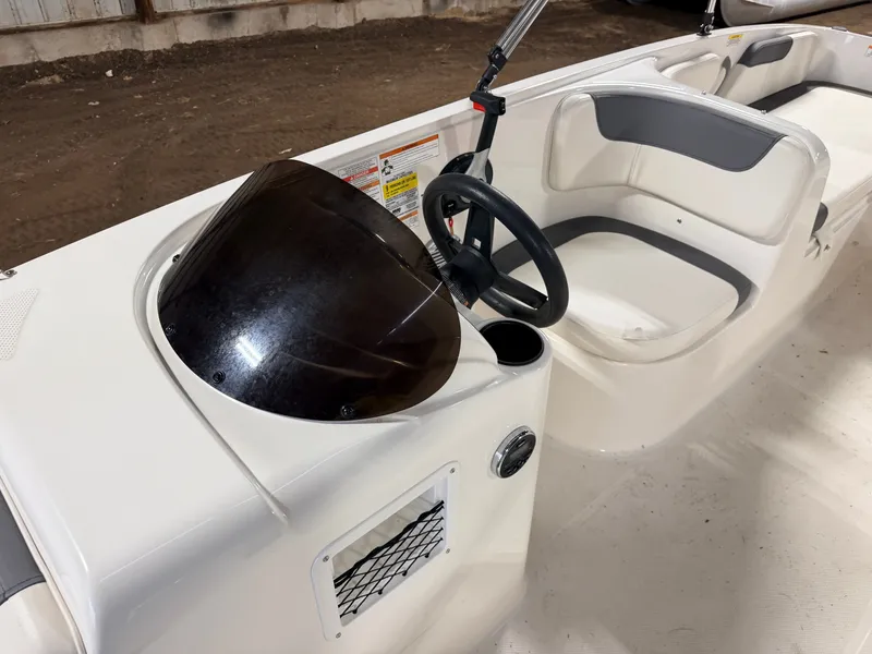 Slide: The Image of Interior of a 2018 Bayliner Element E18 boat with steering console. - 17