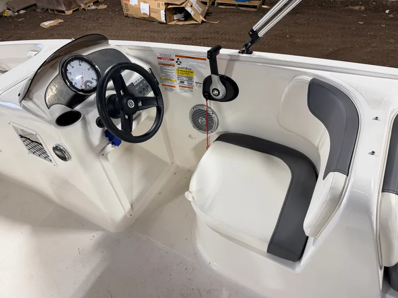 Slide: The Image of Interior of a 2018 Bayliner Element E18 boat with steering console. - 18