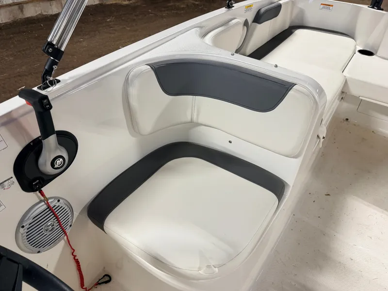 Slide: The Image of Interior of a 2018 Bayliner Element E18 boat with white seating. - 19