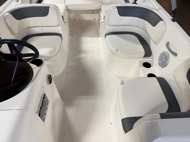 Slide: The Image of Interior of 2018 Bayliner Element E18 boat, featuring white seating. - 25