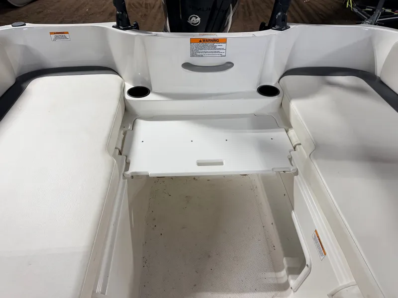 Slide: The Image of Interior of a 2018 Bayliner Element E18 boat with seating area. - 33