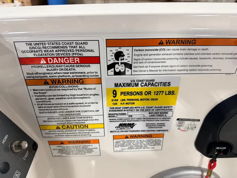 Slide: The Image of Safety warnings and capacity details on a Bayliner Element E18 boat. - 43