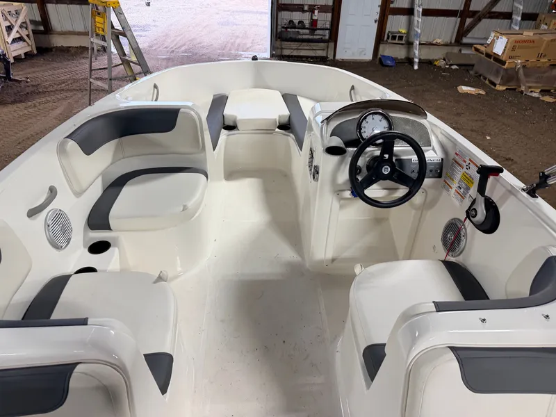 Slide: The Image of Interior of a 2018 Bayliner Element E18 boat with steering console. - 6