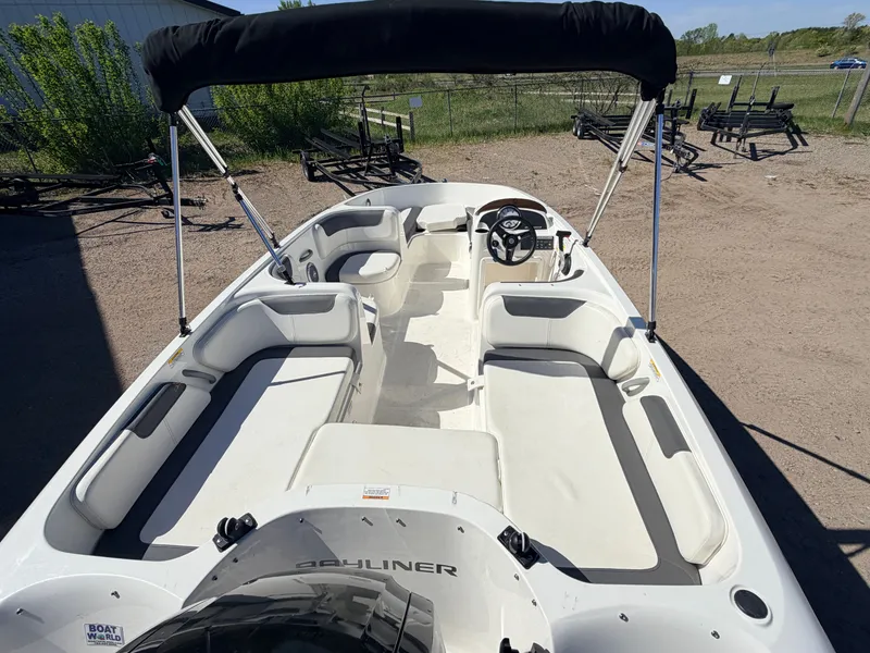 Slide: The Image of 2018 Bayliner Element E18 boat with Bimini top and seating area. - 8
