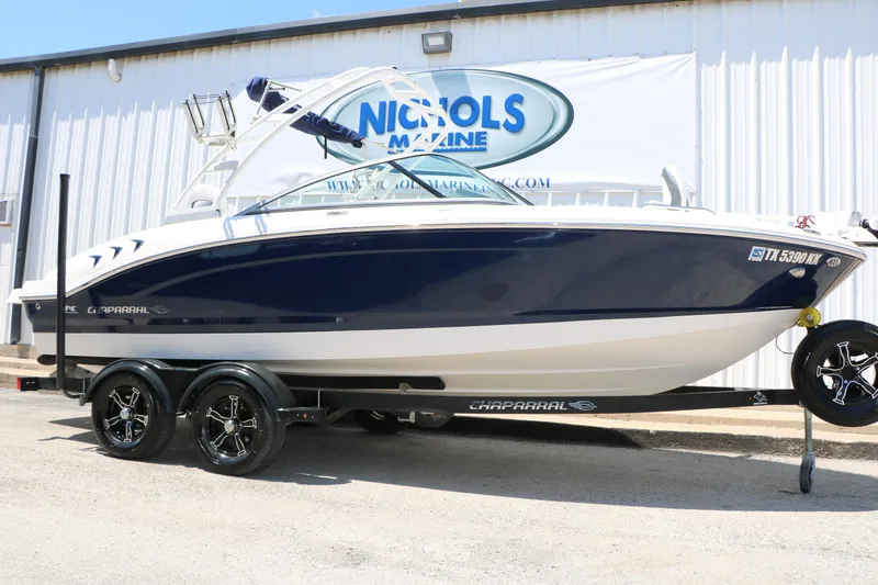 The Image of 2021 Chaparral 21 SSi Ski & Fish boat on trailer, parked outside Nichols Marine. - 1