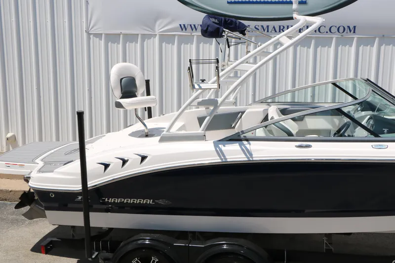Slide: The Image of 2021 Chaparral 21 SSi Ski & Fish boat, sleek design, white and black exterior. - 13