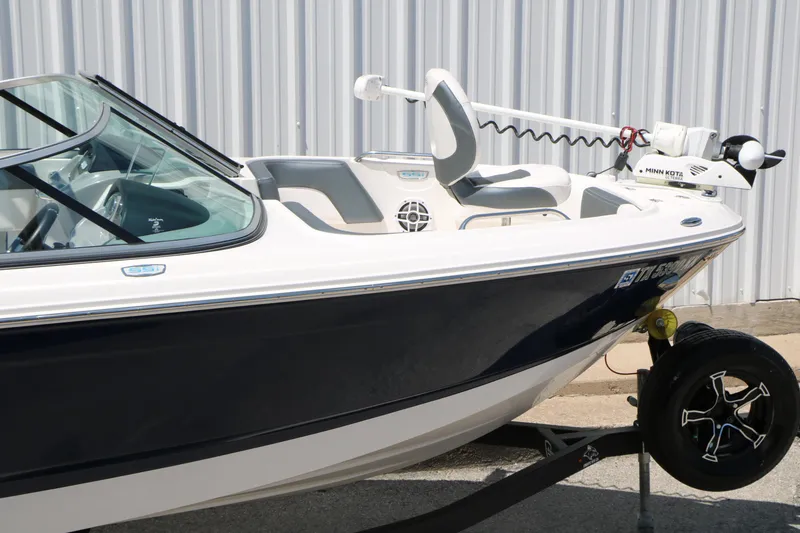 Slide: The Image of 2021 Chaparral 21 SSi Ski & Fish boat on trailer, featuring sleek design and modern equipment. - 14