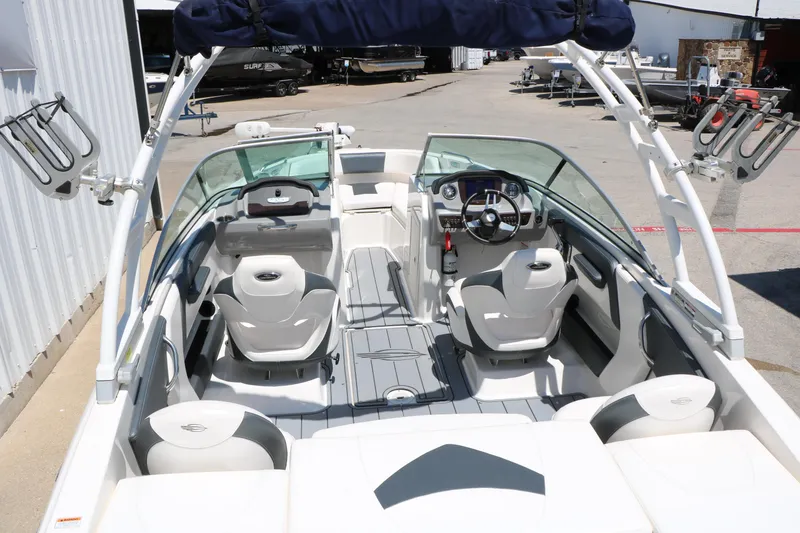 Slide: The Image of 2021 Chaparral 21 SSi Ski & Fish boat interior with seating and steering wheel. - 24
