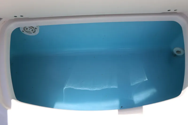 Slide: The Image of Livewell compartment in 2021 Chaparral 21 SSi Ski & Fish boat, featuring blue interior. - 34