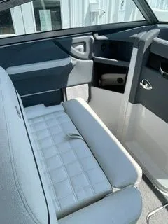 Slide: The Image of Interior of a 2019 Cobalt R5 Surf boat with white leather seats. - 24