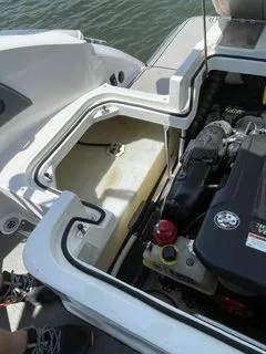 Slide: The Image of Engine compartment of a 2019 Cobalt R5 Surf boat by the water. - 27
