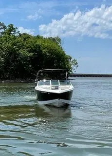 Slide: The Image of 2019 Cobalt R5 Surf boat on calm water near green shoreline. - 3