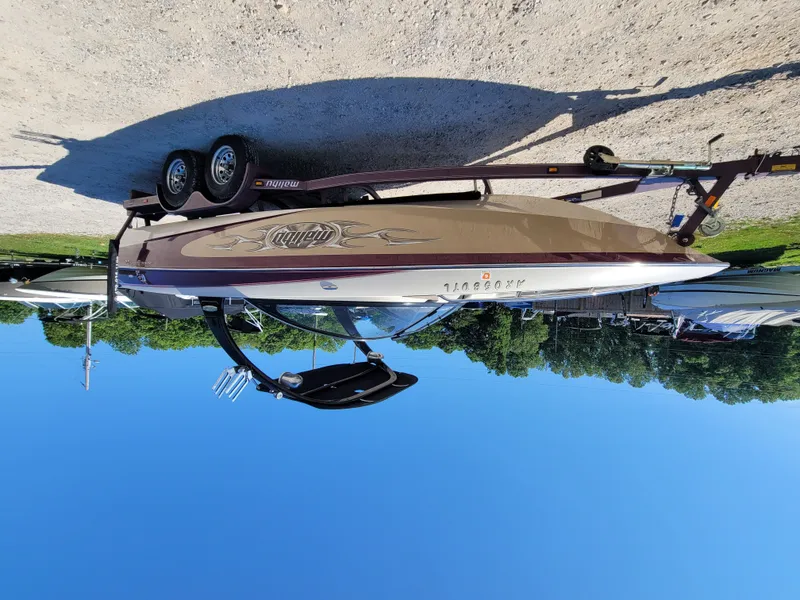 Slide: The Image of 2005 Malibu XTI boat on trailer, sunny day. - 13