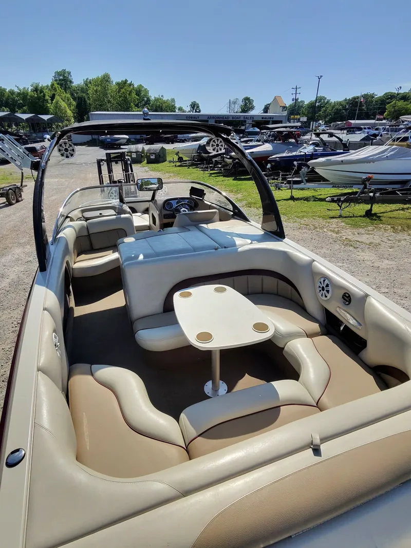 Slide: The Image of Interior of a 2005 Malibu XTI boat with seating area and table. - 3