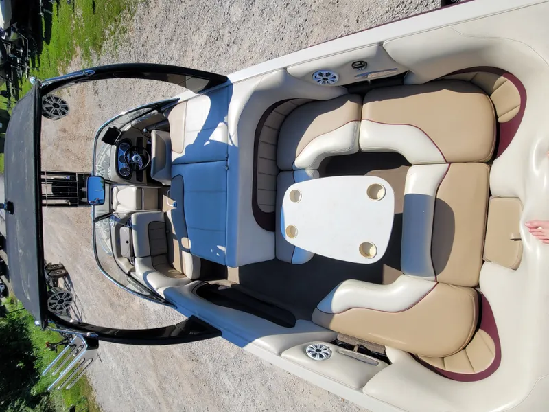 Slide: The Image of Interior of a 2005 Malibu XTI boat with beige seating. - 5