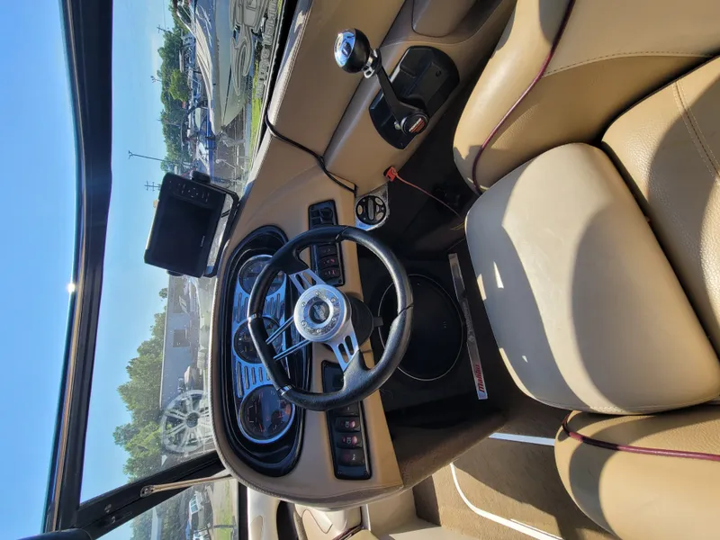Slide: The Image of Interior of a 2005 Malibu XTI boat with steering wheel and dashboard. - 8