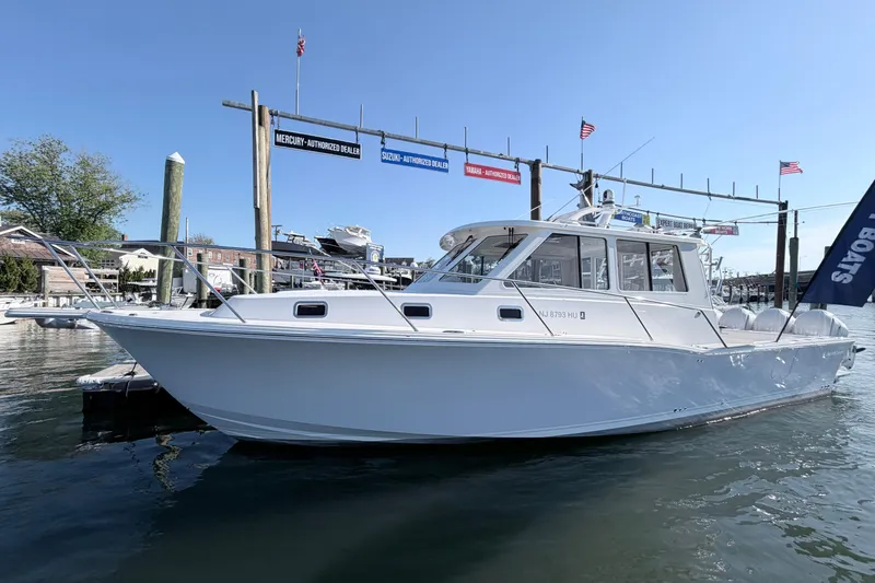 Slide: The Image of 2025 NorthCoast 415 HT boat docked at marina under clear blue sky. - 1