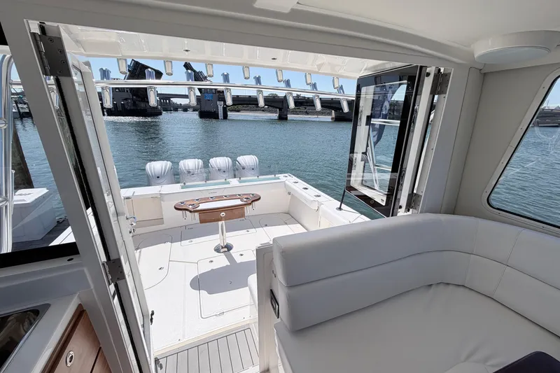 Slide: The Image of Interior view of 2025 NorthCoast 415 HT boat with open deck and water backdrop. - 13
