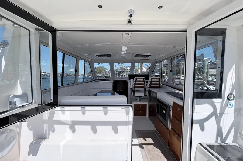 Slide: The Image of Interior view of 2025 NorthCoast 415 HT boat, featuring modern seating and cabinetry. - 15