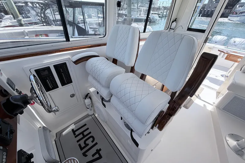Slide: The Image of Luxurious interior of 2025 NorthCoast 415 HT boat with plush white seating. - 20