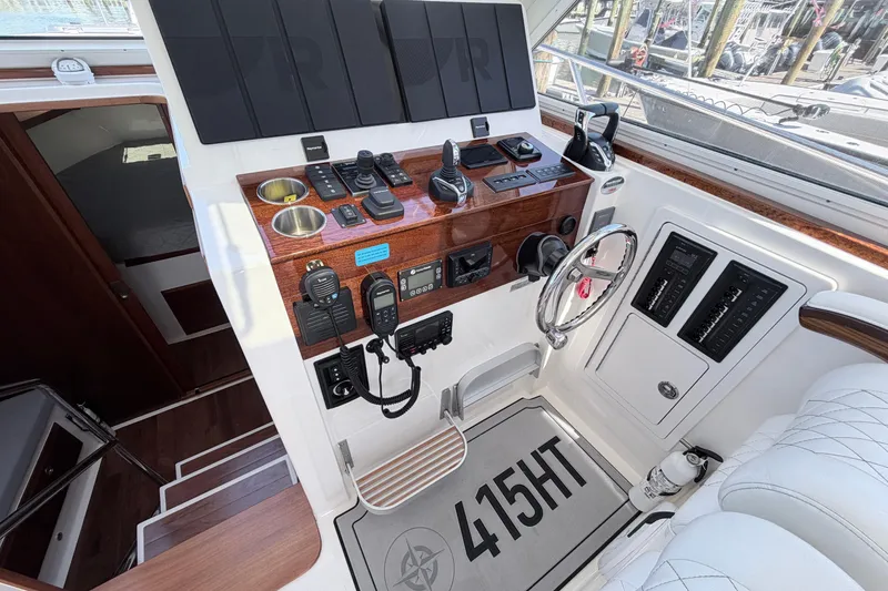 Slide: The Image of Helm of 2025 NorthCoast 415 HT boat with modern controls and steering wheel. - 21