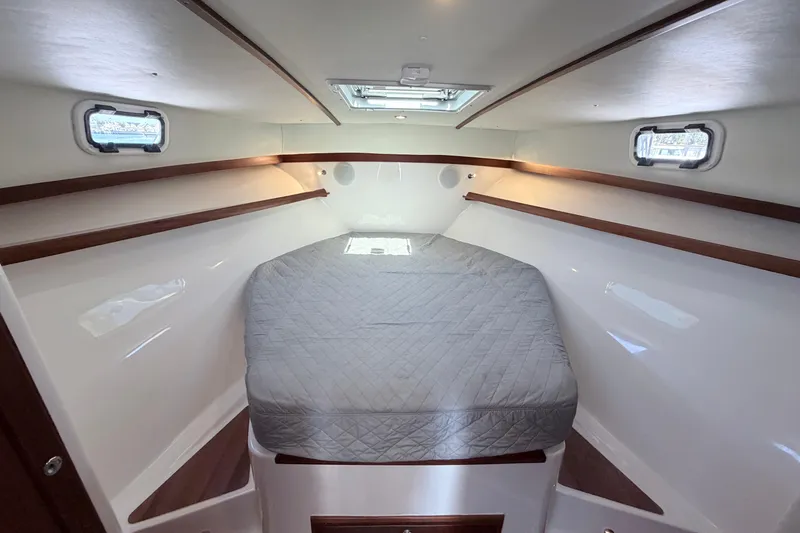 Slide: The Image of Interior cabin of 2025 NorthCoast 415 HT boat with bed and windows. - 23
